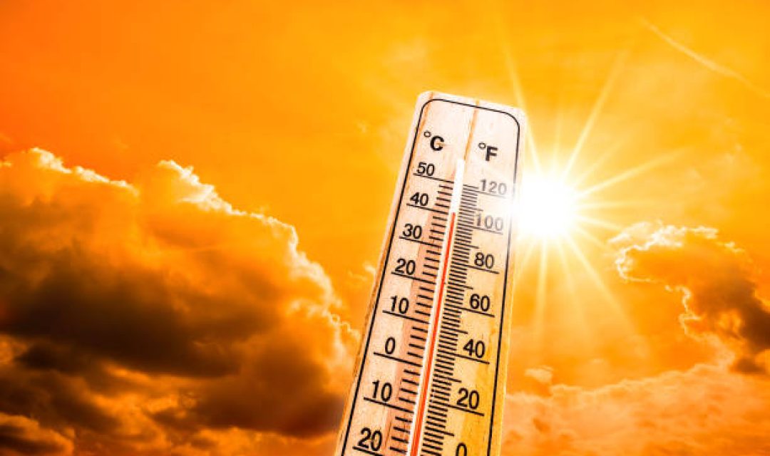 Hot summer or heat wave background, glowing sun on orange sky with thermometer