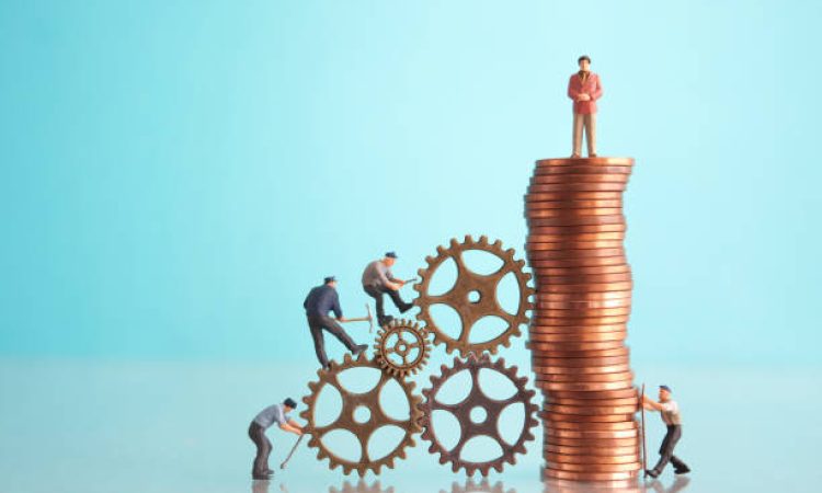 Miniature businessman on top of a pile of coins with construction workers, leadership, success concept