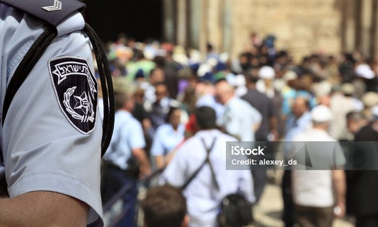 Israel Police Officer in the Crowded Street