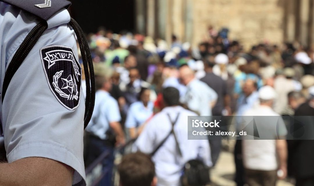 Israel Police Officer in the Crowded Street