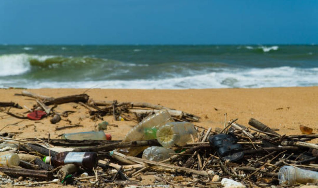 Discarded plastic debris trash pollution after sea swell storm, environmental nature waste. Negombo, Sri Lanka.