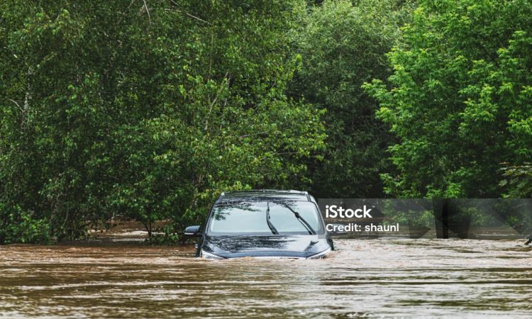 A vehicle sits in deep water after a river overflows following record breaking rainfall.