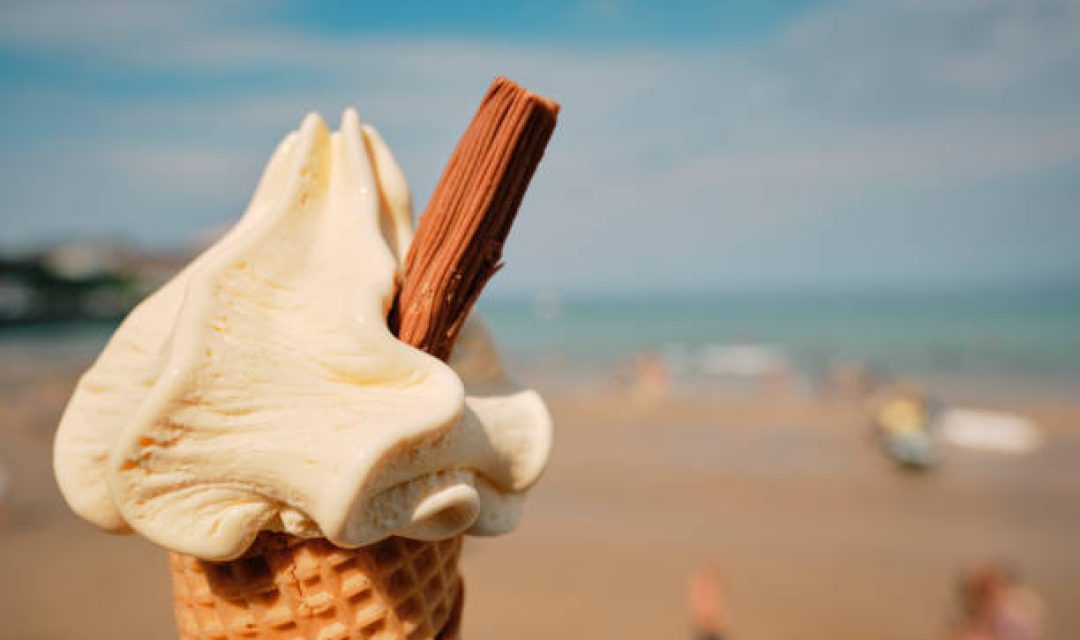 POV of an Ice Cream cone above Towan Beach, Newquay, Cornwall on a sunny September day.